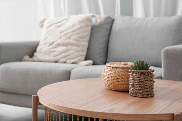 Living room in an independent living apartment at Westhaven in Boone, Iowa featuring a sofa, round wood coffee table, and comfortable seating area.