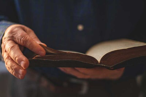 Hands holding an open Bible, representing faith-based support at Westhaven Community.