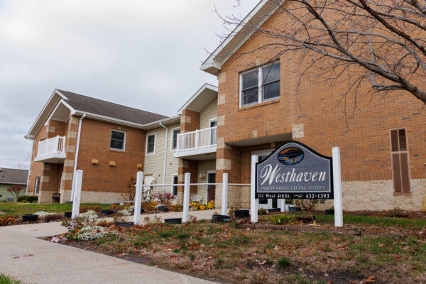 Exterior of Westhaven independent living in Boone, Iowa showing apartment building, entrance, and community sign.
