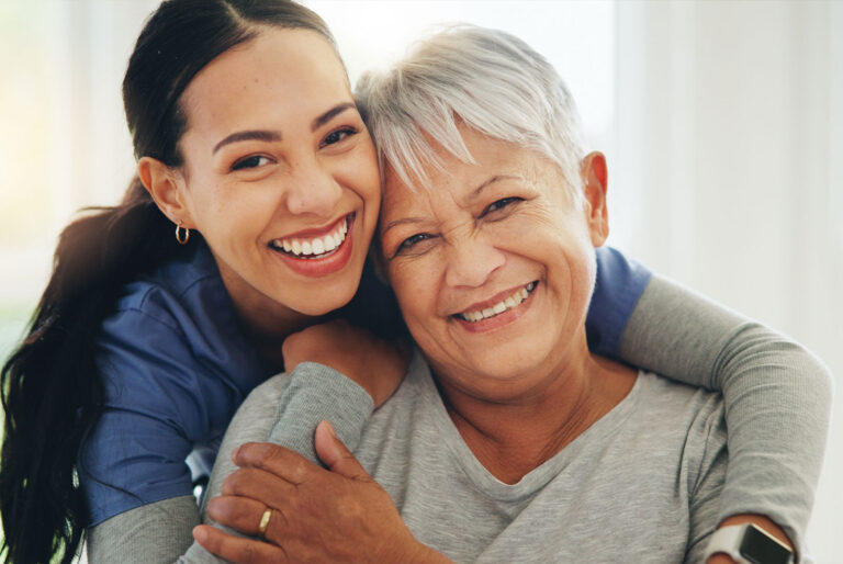 Caregiver embracing an older adult, representing compassionate long-term care support similar to Westhaven Community.