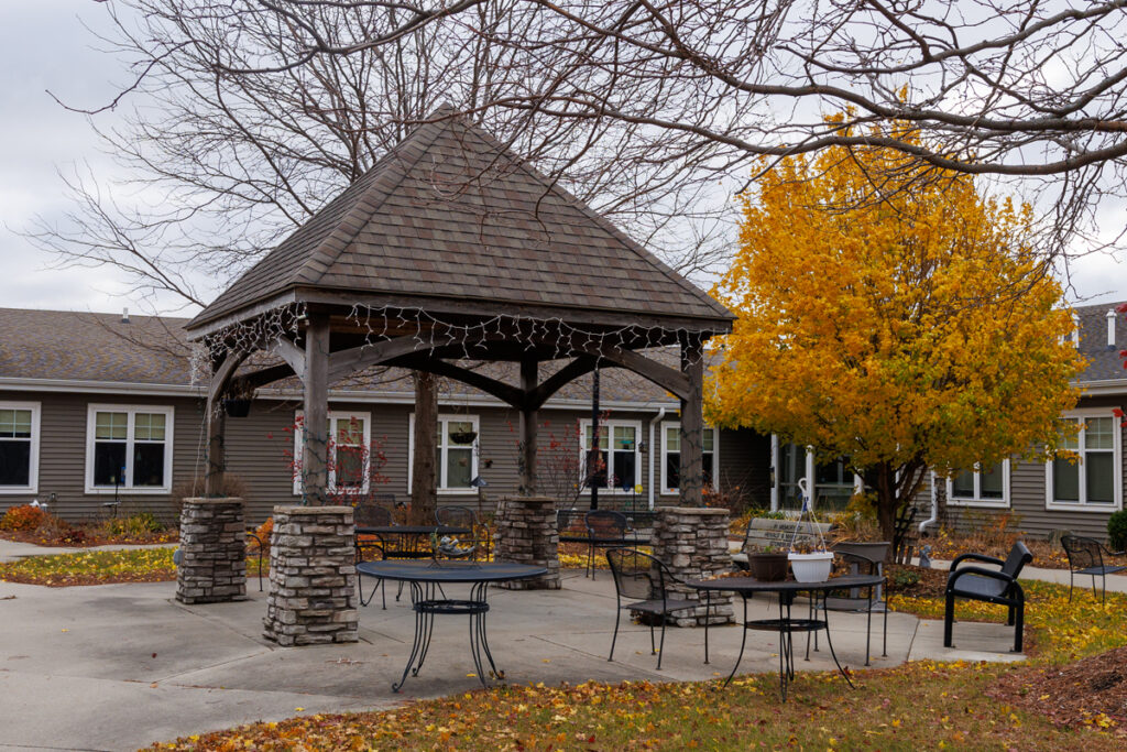 Gazebo and outdoor courtyard at Westhaven Community in Boone, Iowa with patio seating, tables, and landscaped grounds in a garden setting.