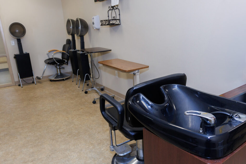 Salon and hair care area at Westhaven Community in Boone, Iowa with wash station, styling chairs, and equipment.