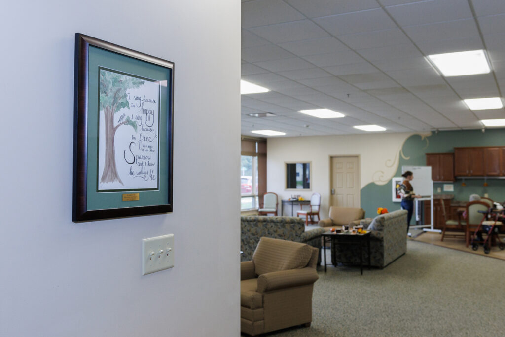 Interior common area at Westhaven Community in Boone, Iowa with seating, wall artwork, and open living space near kitchenette.